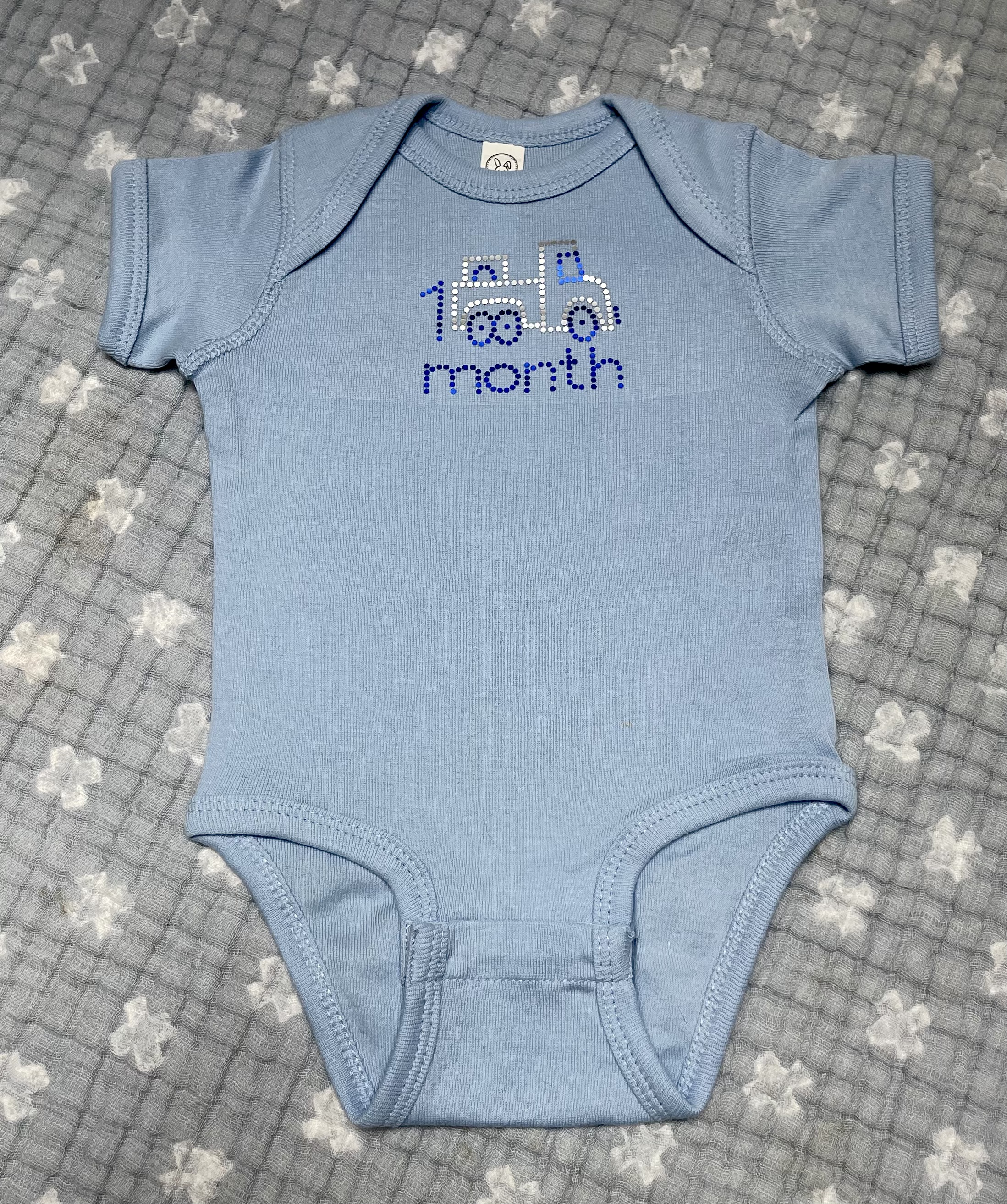 This Month by Month Baby Onesie is made with love by All Branded Out Apparel! Shop more unique gift ideas today with Spots Initiatives, the best way to support creators.